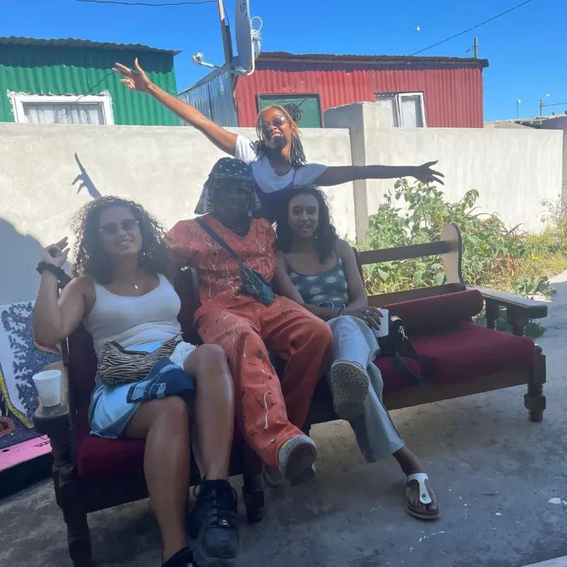 Guests relaxing on a couch in a township yard