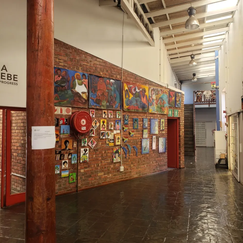 Gallery corridor at Guga S'thebe hung with paintings