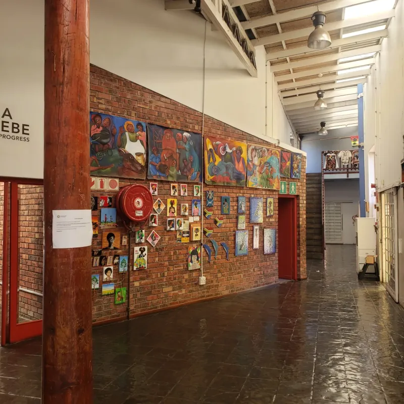 Gallery corridor at Guga S'thebe hung with paintings