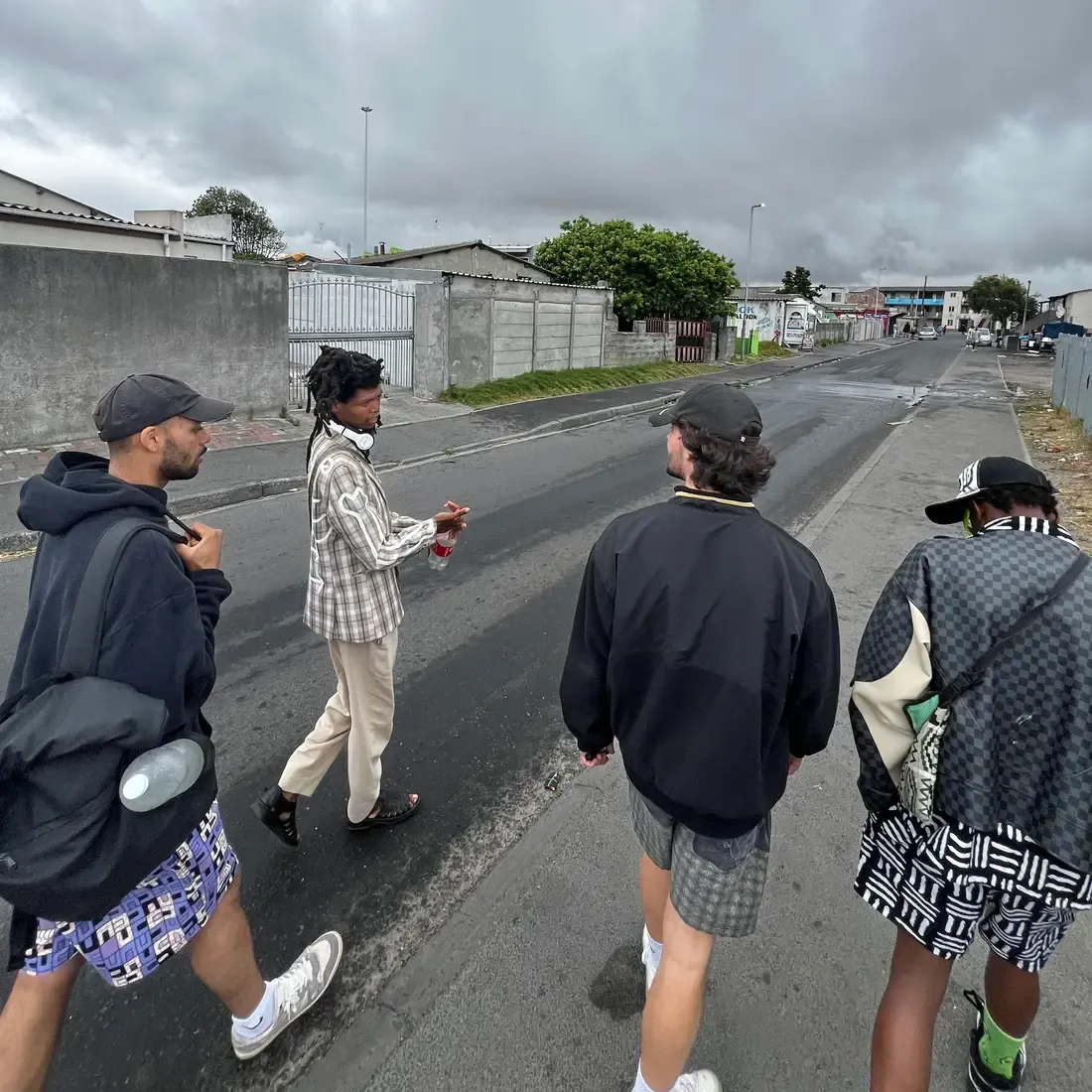 Masande and guests walking down a Langa street