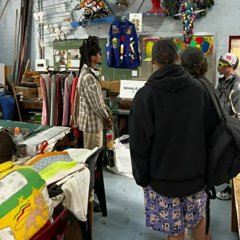 Visitors in the Skhalo clothing workshop