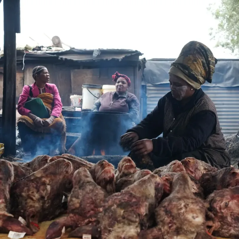 Women cooking smileys at a street food stall